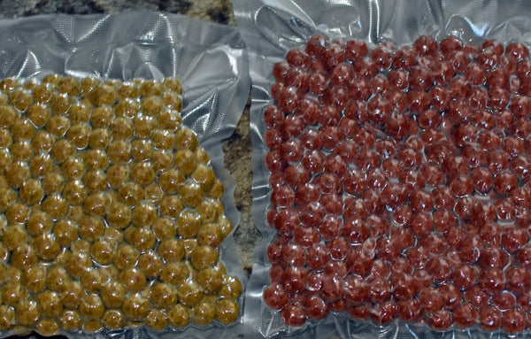 Photo of two bags of fishing bait, one yellow one red, in sealed plastic bags