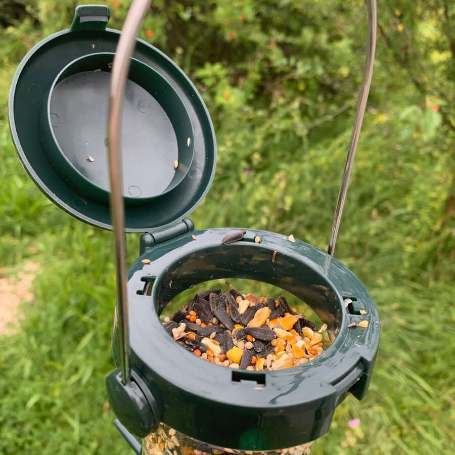 Seed feeder with flick top which is hinged to open easily.
